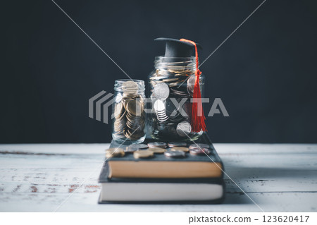 Saving money coin with banking investment, finance education concept. Planning student loan for studying abroad for college or university degree. Future children's education fund cash. Growing Saving money coin with banking investment, finance education concept. Planning student loan for studying abroad for college or university degree. Future children's education fund cash. Growing 123620417