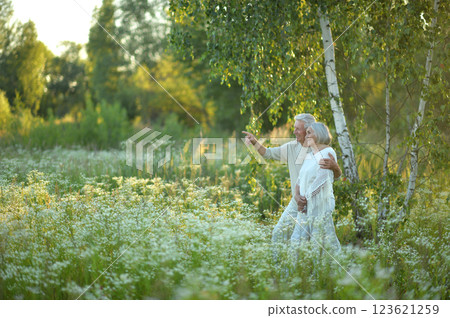 Loving mature couple in the park in summer Loving mature couple in the park in summer 123621259