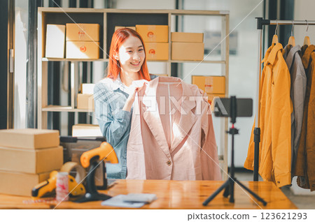 SME owner using the smartphone and tablet for recording video. vlog and live stream at her shop,SME business concept, online shopping. 123621293