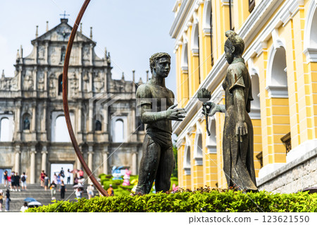 A sculpture of a young man and woman in front of the Ruins of St. Paul's at Jesus Company Square in Macau symbolizes the friendship between China and Portugal. 123621550