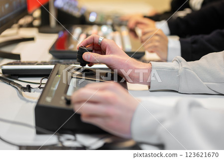 Video editor working with footage using modern video editing software and hardware control panel Video editor working with footage using modern video editing software and hardware control panel 123621670