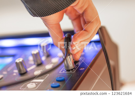 Sound engineer using digital audio mixer sliders Engineer pressing keys adds control panel volume Sound engineer using digital audio mixer sliders Engineer pressing keys adds control panel volume 123621684