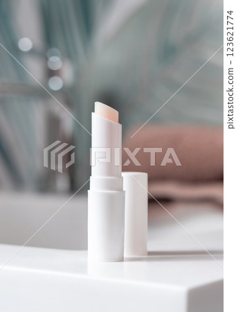 Opened white blank lip balm stick on basin in tropical bathroom close up, cosmetic mockup Opened white blank lip balm stick on basin in tropical bathroom close up, cosmetic mockup 123621774