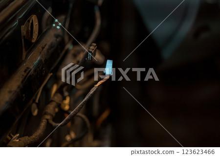 Close-up View of a Loose Electrical Wiring Harness Connector in Vehicle Repair and Maintenance 123623466