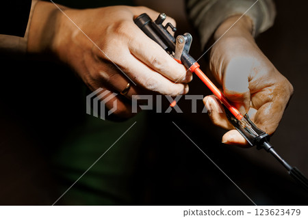 Precision Tooling: A Craftsman's Hand at Work on a Mechanical Component 123623479