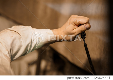 Craftsmanship in Action: Close-up of an Artist's Hand at Work 123623481