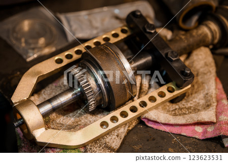 Close-Up View of Automotive Wheel Bearing Extractor Tool Removing a Bearing from a Vehicle Axle, Displaying Industrial Maintenance and Repair Concept 123623531