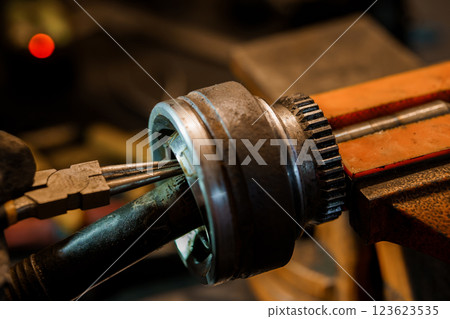 Detailed Close-up of a Heavy-Duty Mechanical Tool in a Workshop Setting Detailed Close-up of a Heavy-Duty Mechanical Tool in a Workshop Setting 123623535