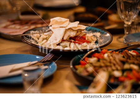 An Abundant Mediterranean Feast with Fresh Ingredients on an Elegant Dining Table An Abundant Mediterranean Feast with Fresh Ingredients on an Elegant Dining Table 123623615
