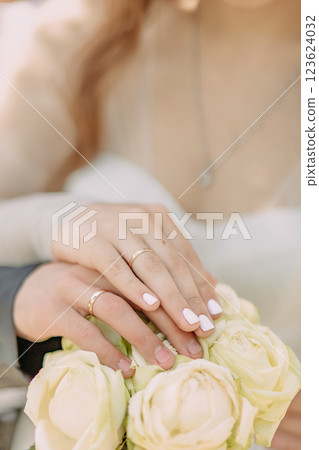 The bride and groom show wedding rings, the hands of two lovers 123624032