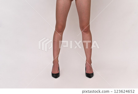 beautiful female feet in shoes on a white background 123624652