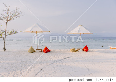 Chairs and umbrella at luxury beach. Tropical holiday banner with ocean Chairs and umbrella at luxury beach. Tropical holiday banner with ocean 123624717