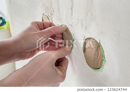 Preparing socket boxes for puttying work. 123624744