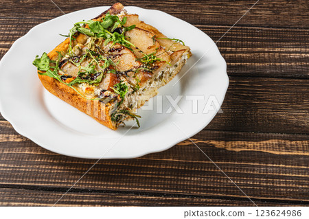 Delicious homemade savory pastry with fresh herbs on a rustic wooden table Delicious homemade savory pastry with fresh herbs on a rustic wooden table 123624986