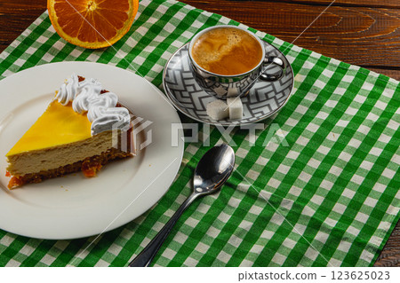 Citrus cheesecake with espresso on a cozy table setting 123625023