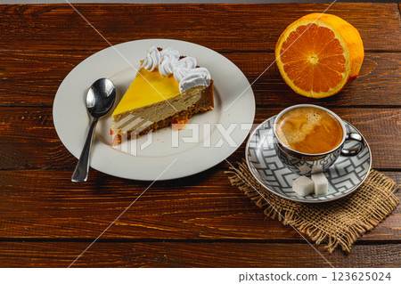 Enjoying a delicious slice of orange cheesecake with coffee on a rustic table 123625024