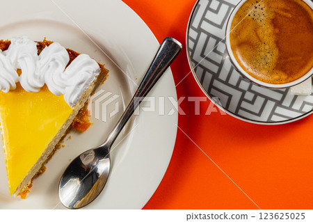 Enjoying a delightful slice of cake alongside a steaming cup of coffee 123625025