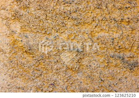 rugged beige concrete wall texture with pebbles rugged beige concrete wall texture with pebbles 123625210