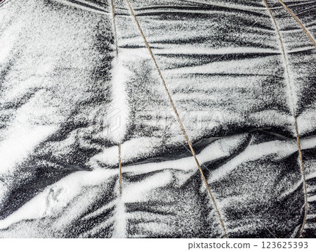 snow covered black tarp 123625393