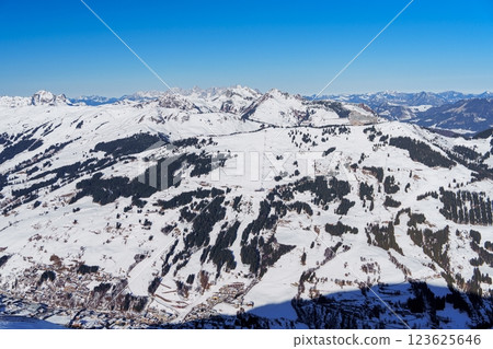 Spectacular snow-covered mountain range with village in the distance Spectacular snow-covered mountain range with village in the distance 123625646