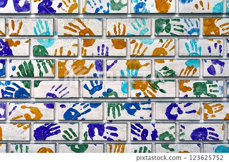Hand shapes marked on a wall with paint 123625752