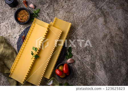 Uncooked lasagna pasta with cooking ingredient Uncooked lasagna pasta with cooking ingredient 123625823
