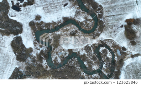 Inland river winter snow delta river ice frost meanders drone aerial freezing shot in floodplain forest lowlands wetland swamp, quadcopter view, protected landscape area Ltovelske Pomoravi Europe 123625846