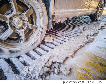 car covered with soap sud at winter outdoor self-service car wash 123626450