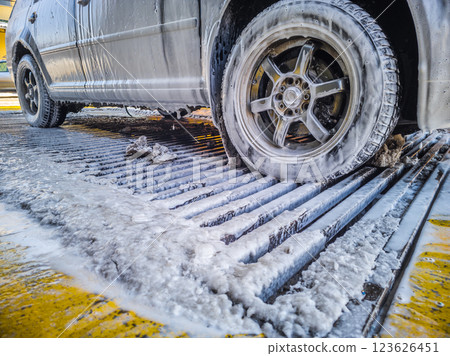 car covered with soap sud at winter outdoor self-service car wash 123626451