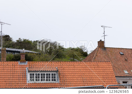 Old house with orange tiled roof and window 123626565