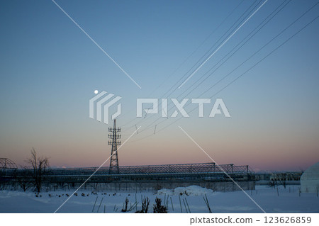 Snow-covered fields and power line towers 123626859