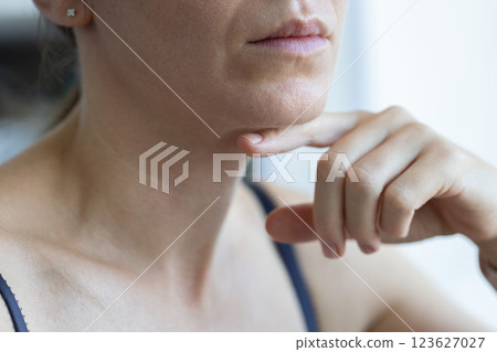 Woman trying to keep her head level for correct posture. 123627027