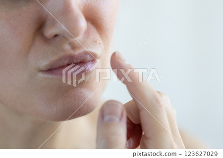 Unhappy woman has excessive hair on her face. Closeup. Unhappy woman has excessive hair on her face. Closeup. 123627029