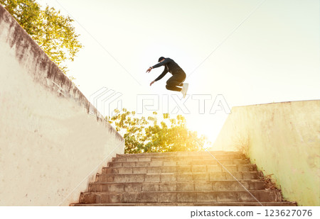 Man doing parkour jumping walls. Latin man doing parkour jumping walls, Low angle of man doing parkour at sunset Man doing parkour jumping walls. Latin man doing parkour jumping walls, Low angle of man doing parkour at sunset 123627076