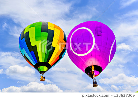 Colorful hot air balloon flying over blue sky with white clouds	 123627309