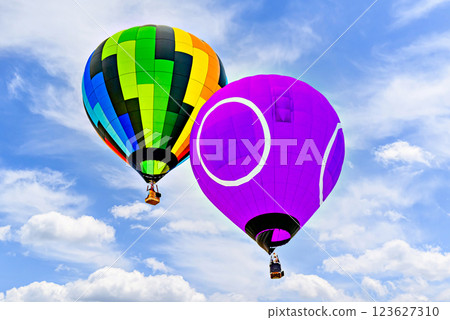 Colorful hot air balloon flying over blue sky with white clouds	 123627310