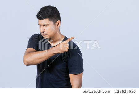 Angry person pointing to get out, Get out, annoyed bearded man looking to the side and pointing finger, angry man pointing to get out 123627656