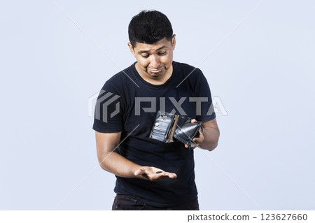 Unhappy and surprised people looking into an empty wallet, guy seeing his empty wallet, Man with financial problems, Sad man holding empty wallet and looking at the camera Unhappy and surprised people looking into an empty wallet, guy seeing his empty wallet, Man with financial problems, Sad man holding empty wallet and looking at the camera 123627660