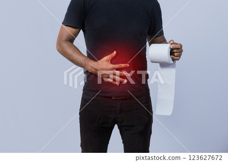 People with stomach problems holding toilet paper, Person with toilet paper with stomach problems on isolated background, Concept of a person with digestive problems People with stomach problems holding toilet paper, Person with toilet paper with stomach problems on isolated background, Concept of a person with digestive problems 123627672