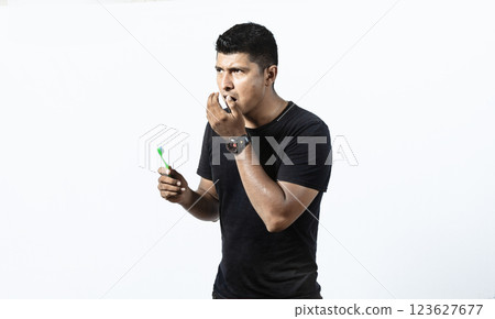 Man with brush and bad breath, Concept of person with halitosis, Person with brush with bad breath problem 123627677