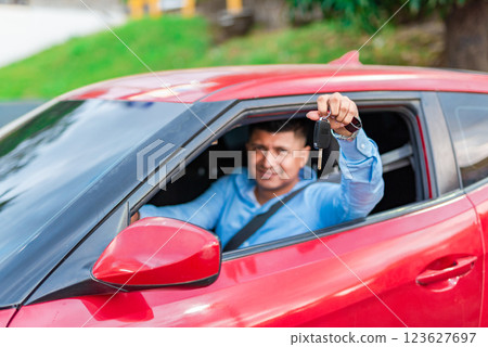 Male driver showing his car keys. Happy driver showing car key 123627697