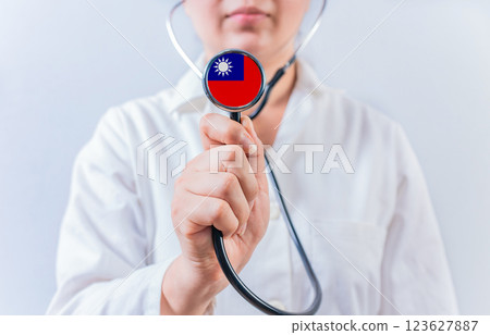 Female doctor holding stethoscope with Taiwan flag. National health system of Taiwan Female doctor holding stethoscope with Taiwan flag. National health system of Taiwan 123627887