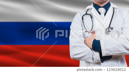 Male Doctor With Stethoscope On Russian Flag. Doctor Holding Stethoscope On Russian Flag Male Doctor With Stethoscope On Russian Flag. Doctor Holding Stethoscope On Russian Flag 123628012
