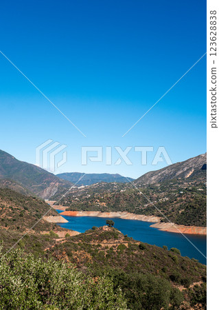 Scenic mountainous landscape with lush greenery and serene lake under clear blue sky, La Concepcion 123628838