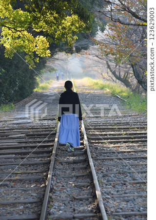 Abandoned railway line in Kyoto, people walking along the tracks 123629003