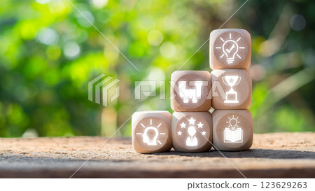 Wooden blocks with icons symbolizing success and achievement, set against a natural background, inspire motivation and results. 123629263