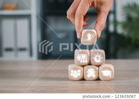 Wooden cubes with business icons symbolize the strategic elements of a Master of Business Administration. 123629267