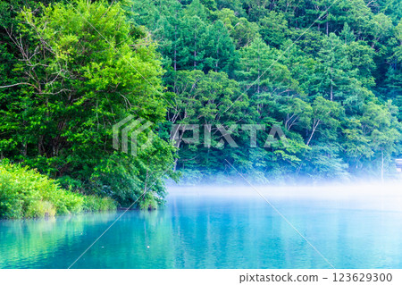 Summer in Kamikochi: Taisho Pond with morning mist Summer in Kamikochi: Taisho Pond with morning mist 123629300