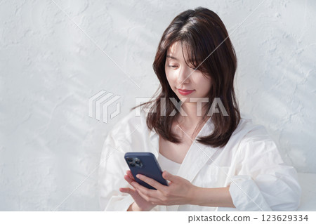 A young woman using a smartphone 123629334