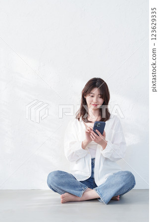 A young woman using a smartphone 123629335